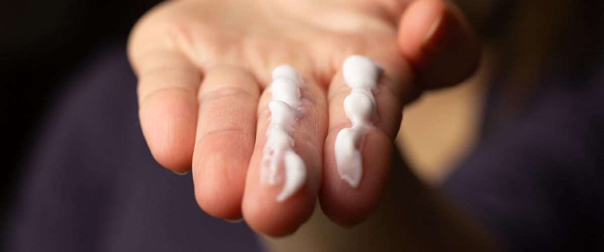 A line of sunscreen on middle and index fingers